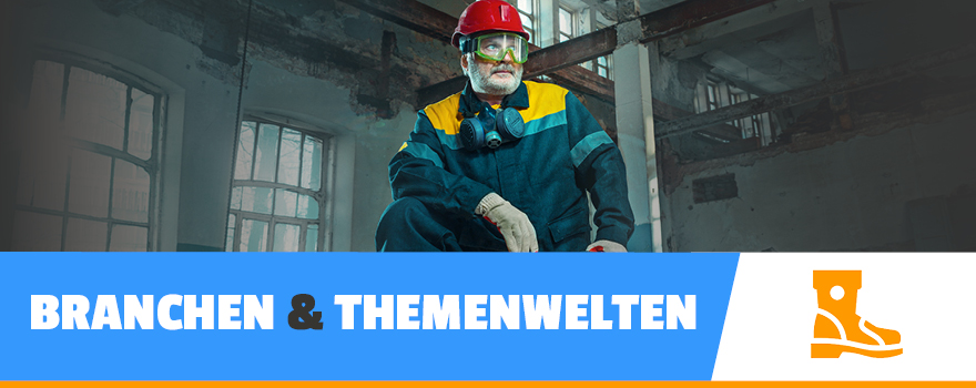 Ein Mann in Arbeitskleidung und Schutzhelm steht in einem industriellen Raum- zur  Branchen und Themen.